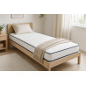 Matelas 90x190 15 cm Calinuit posé sur un lit une place dans une chambre lumineuse